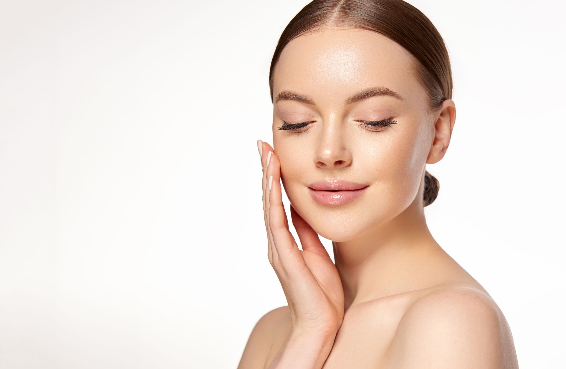 a woman with her eyes closed touches her face with her hand