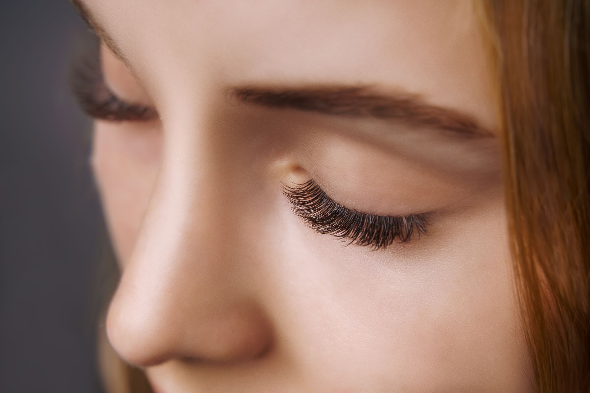 a close up of a woman 's face with her eyes closed