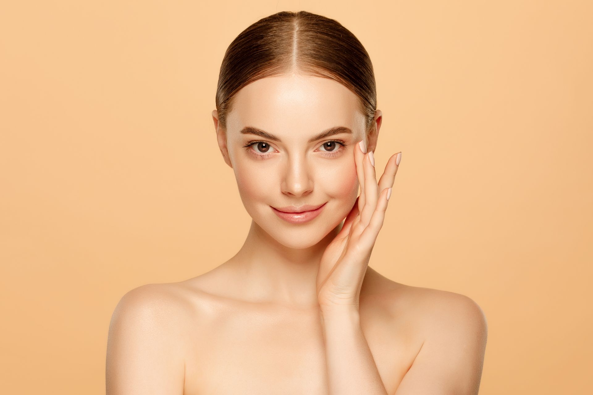 a woman is touching her face with her hand and smiling