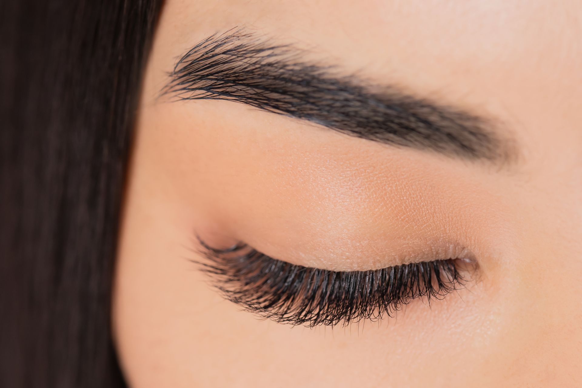 a close up of a woman 's eye with long eyelashes