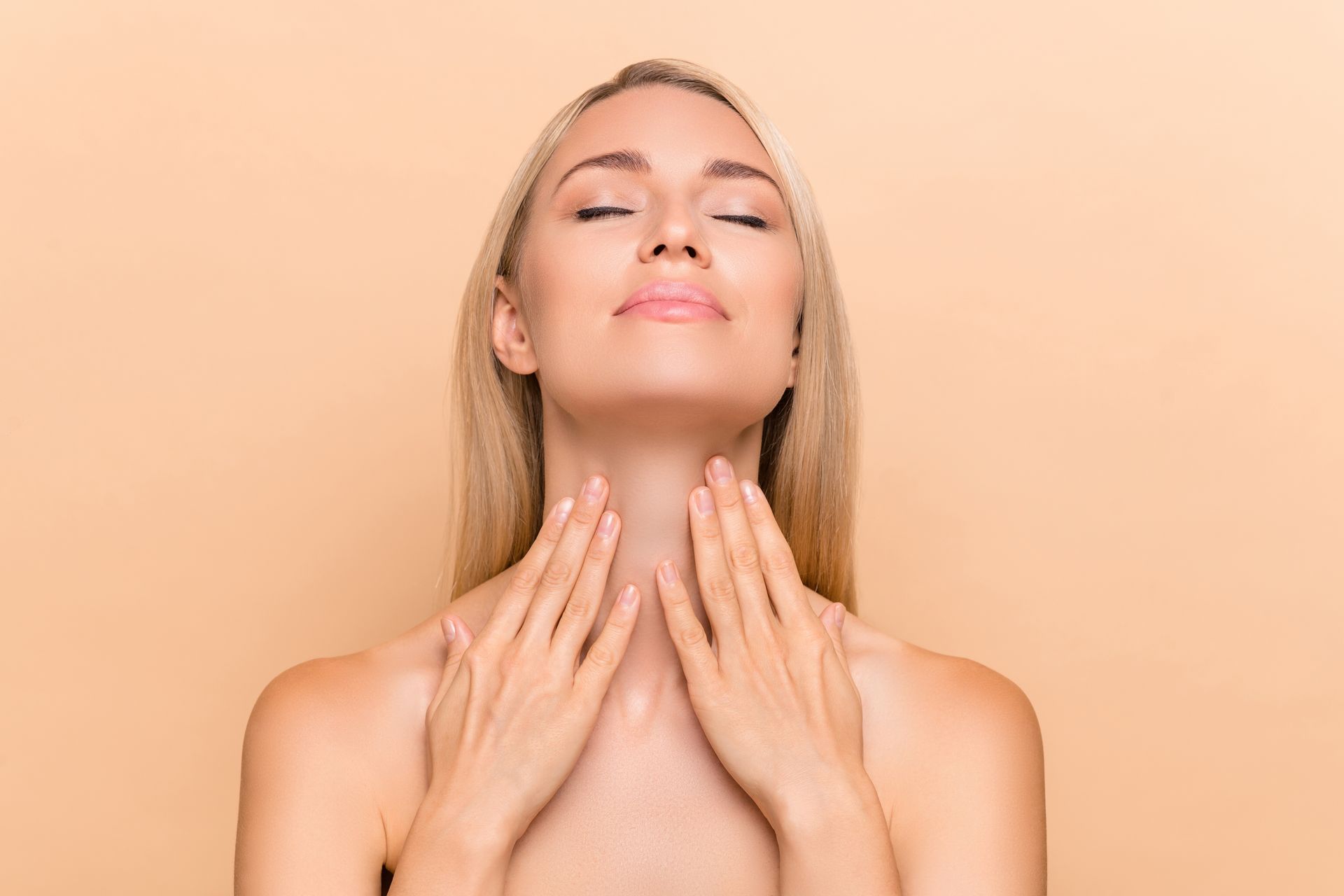 a woman with her eyes closed touches her neck with her hands