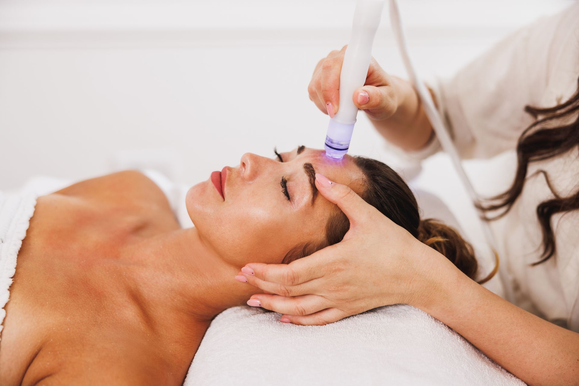 a woman is getting a treatment on her face