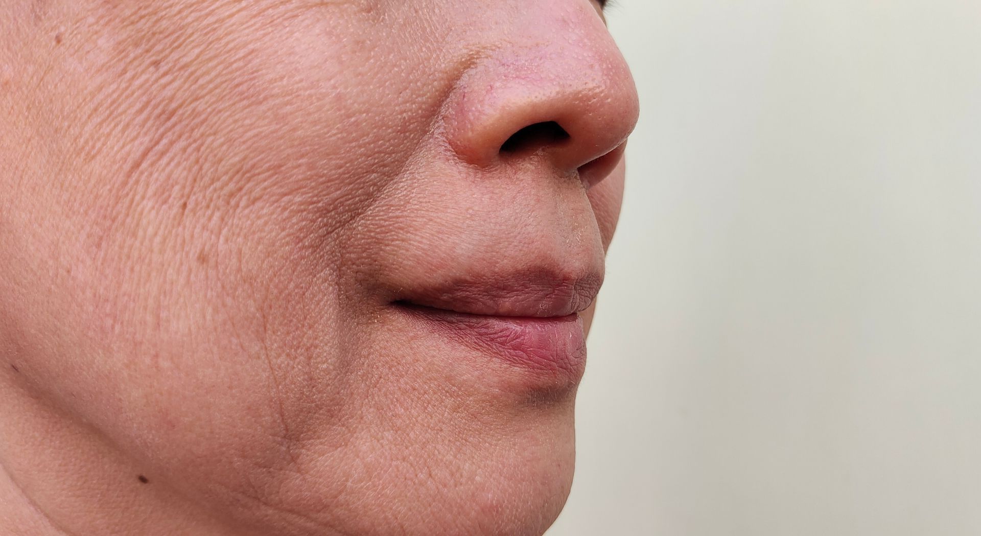 a close up of a woman 's face with her mouth open
