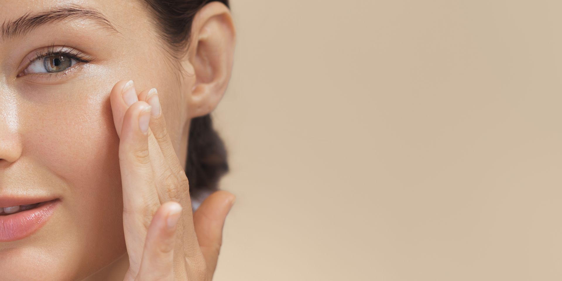 a close up of a woman 's face with her hand on it