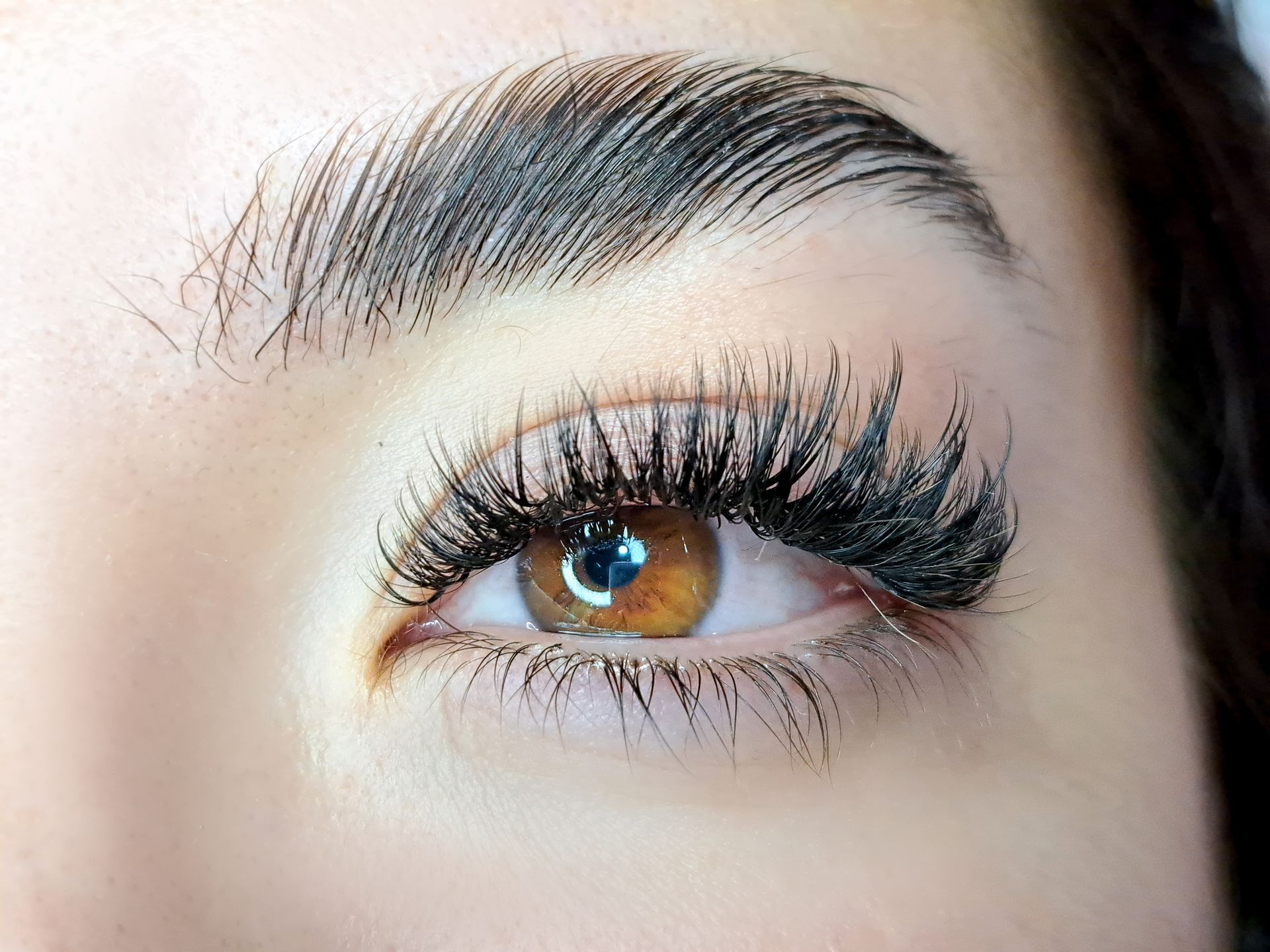 a close up of a woman 's eye with long eyelashes