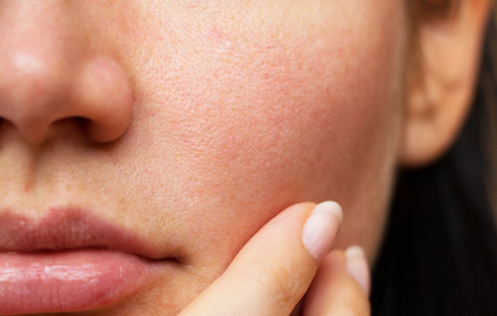 a close up of a woman 's face with a hand on it