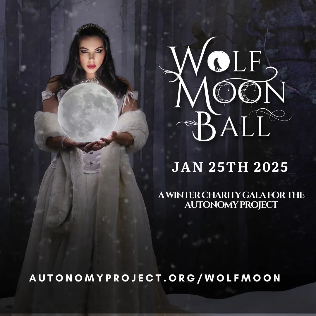 Woman in gown holds glowing moon; Wolf Moon Ball charity event, January 25, 2025.