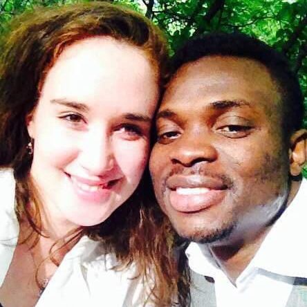 A man and a woman are posing for a picture together and smiling.