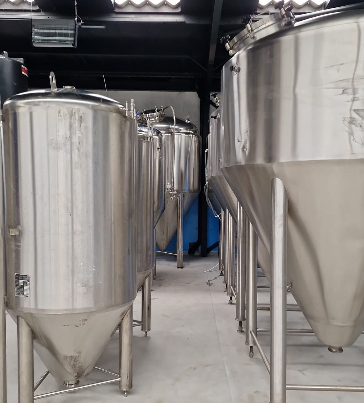 A row of stainless steel tanks with the number 15 on them