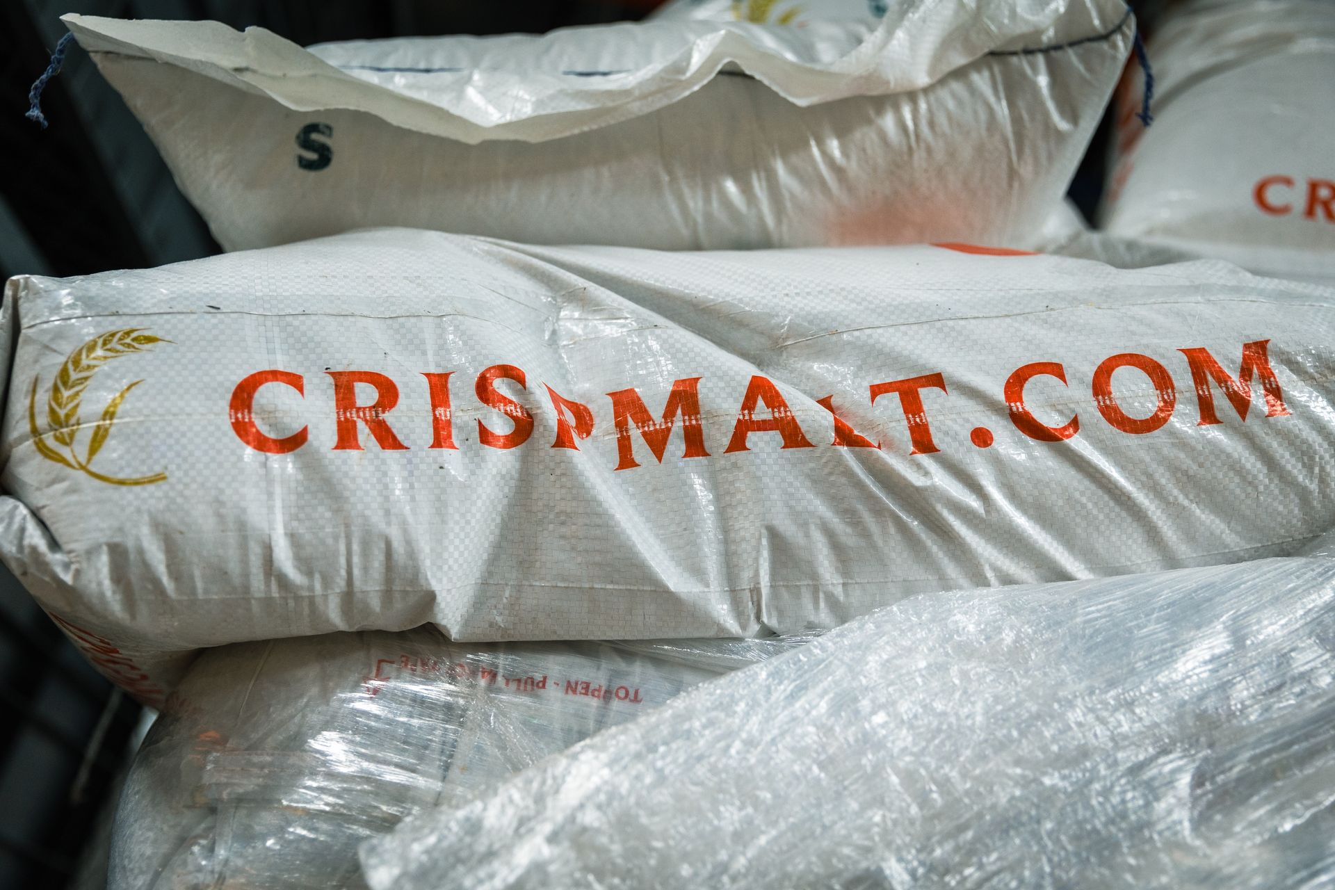A bag of crispmalt.com sits on top of a pile of bags
