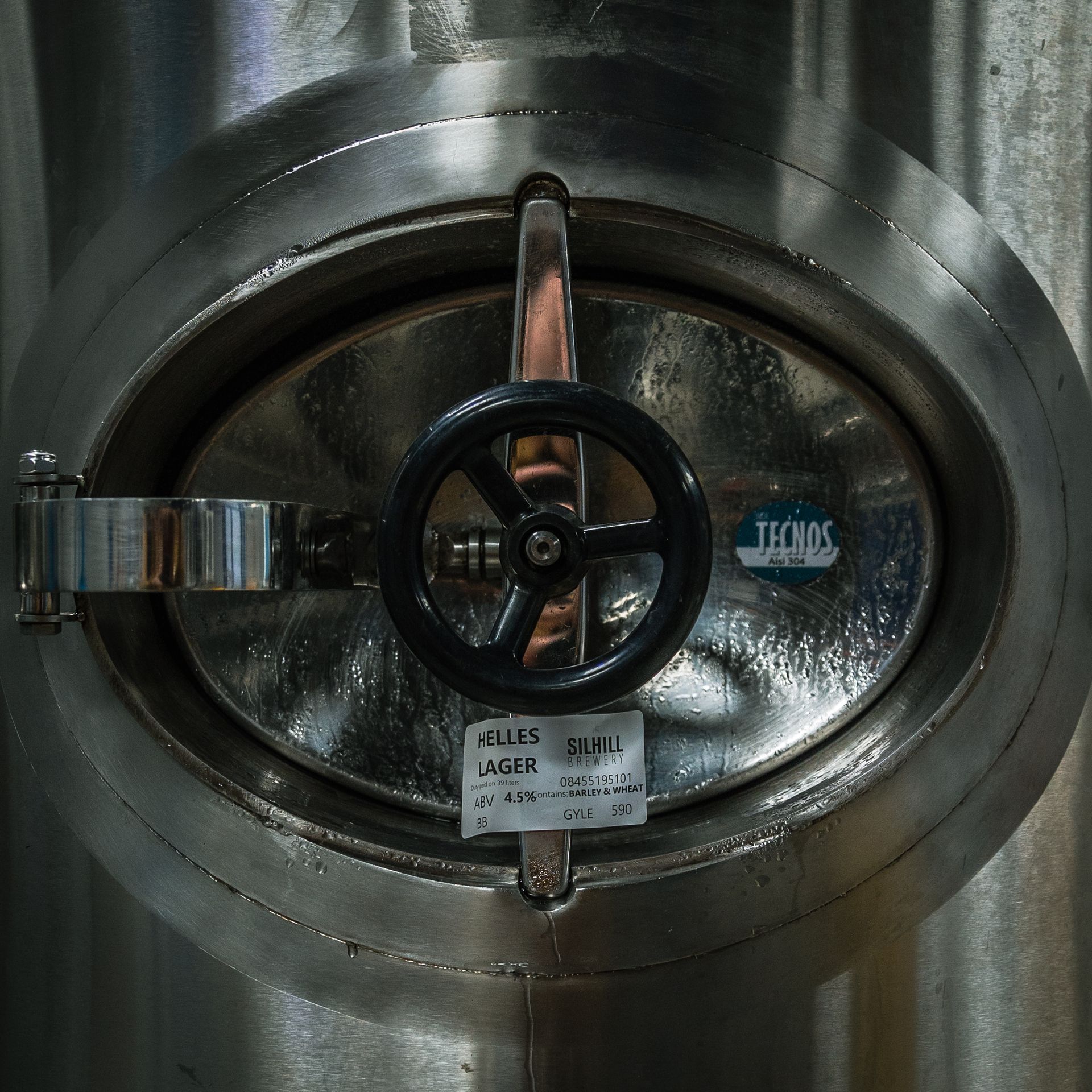 A stainless steel door with a label that says thermos on it