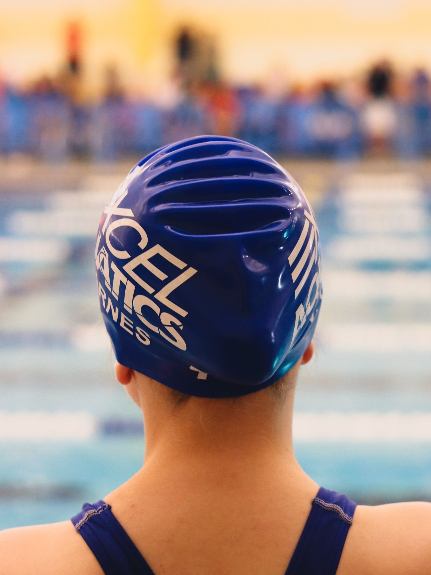 The back of an athlete's head wearing an Excel Aquatics swim cap.
