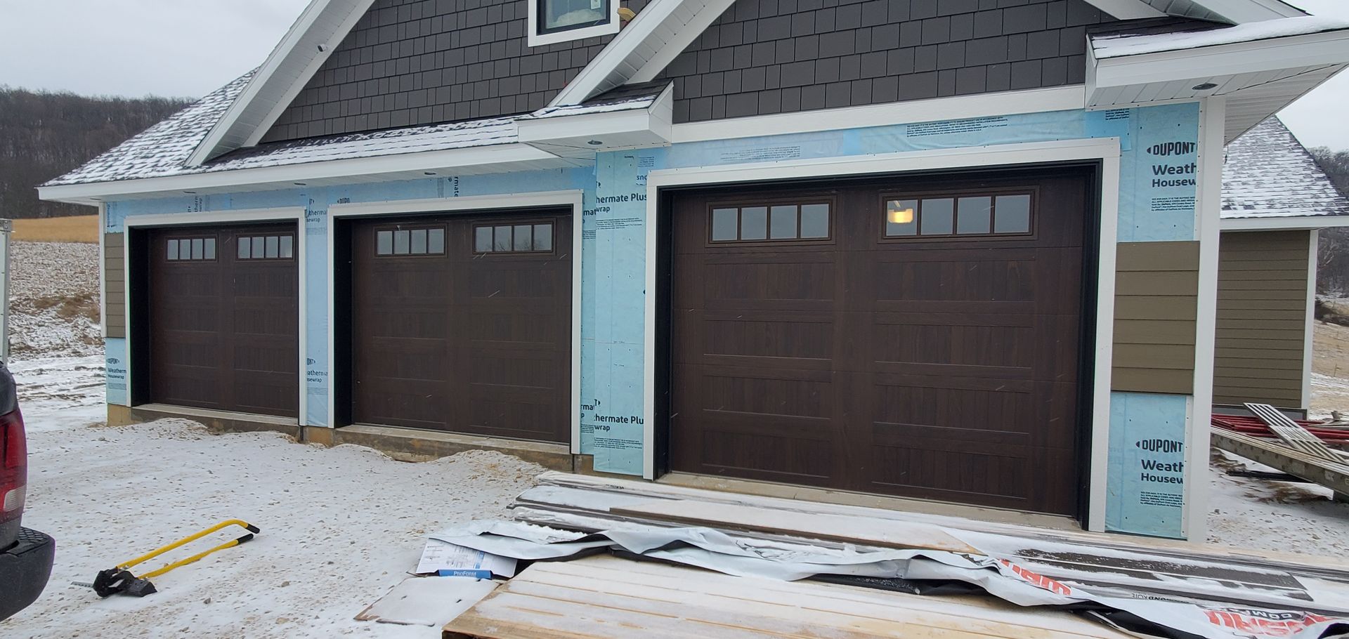 A garage door is being installed on the side of a house.