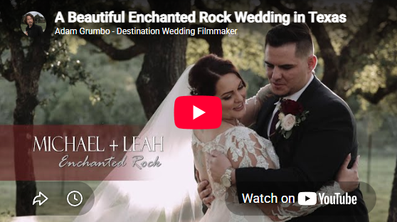 Wedding couple embracing in a rustic outdoor setting with a red play button overlay and title text.