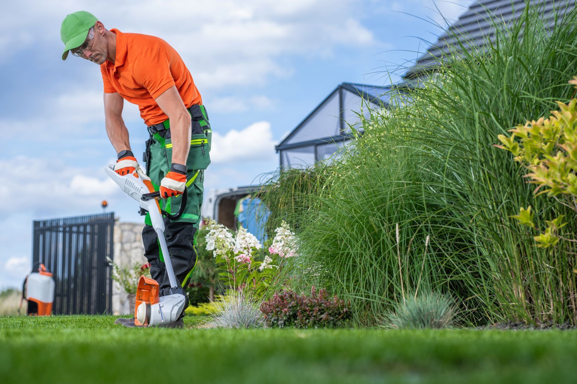 Athens Gardener trimming lush lawn with precision and care.