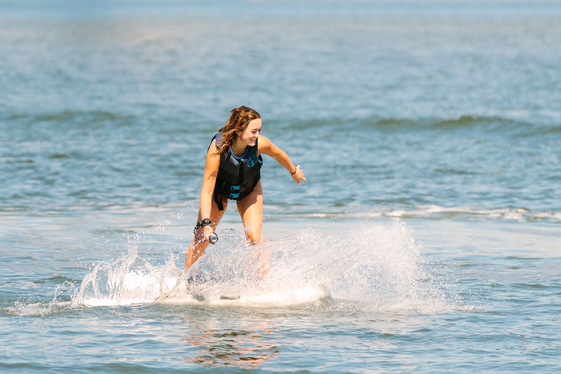 Person riding an eFoil Board and making a splash.