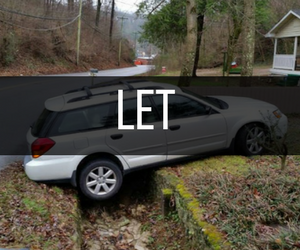 Gray station wagon, one wheel in a ditch, near a road. 