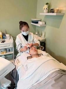 A woman is giving a man a facial treatment in a beauty salon