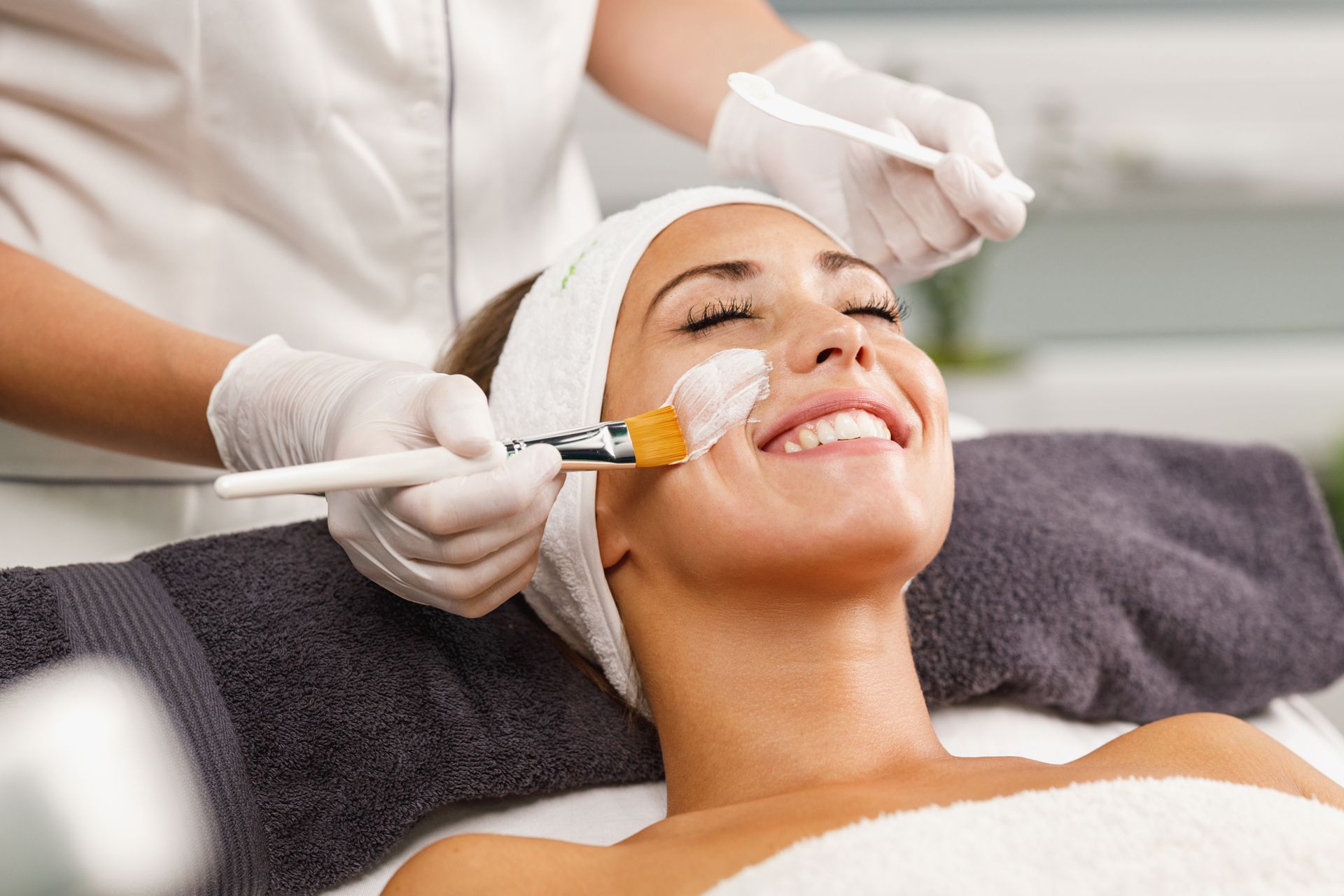 A woman is getting a facial treatment