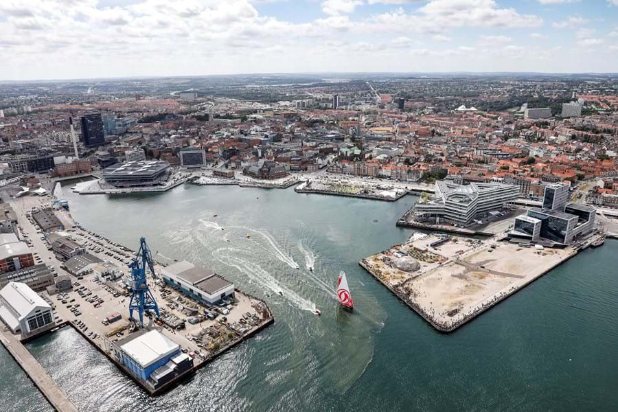 An aerial view of a large body of water with a city in the background