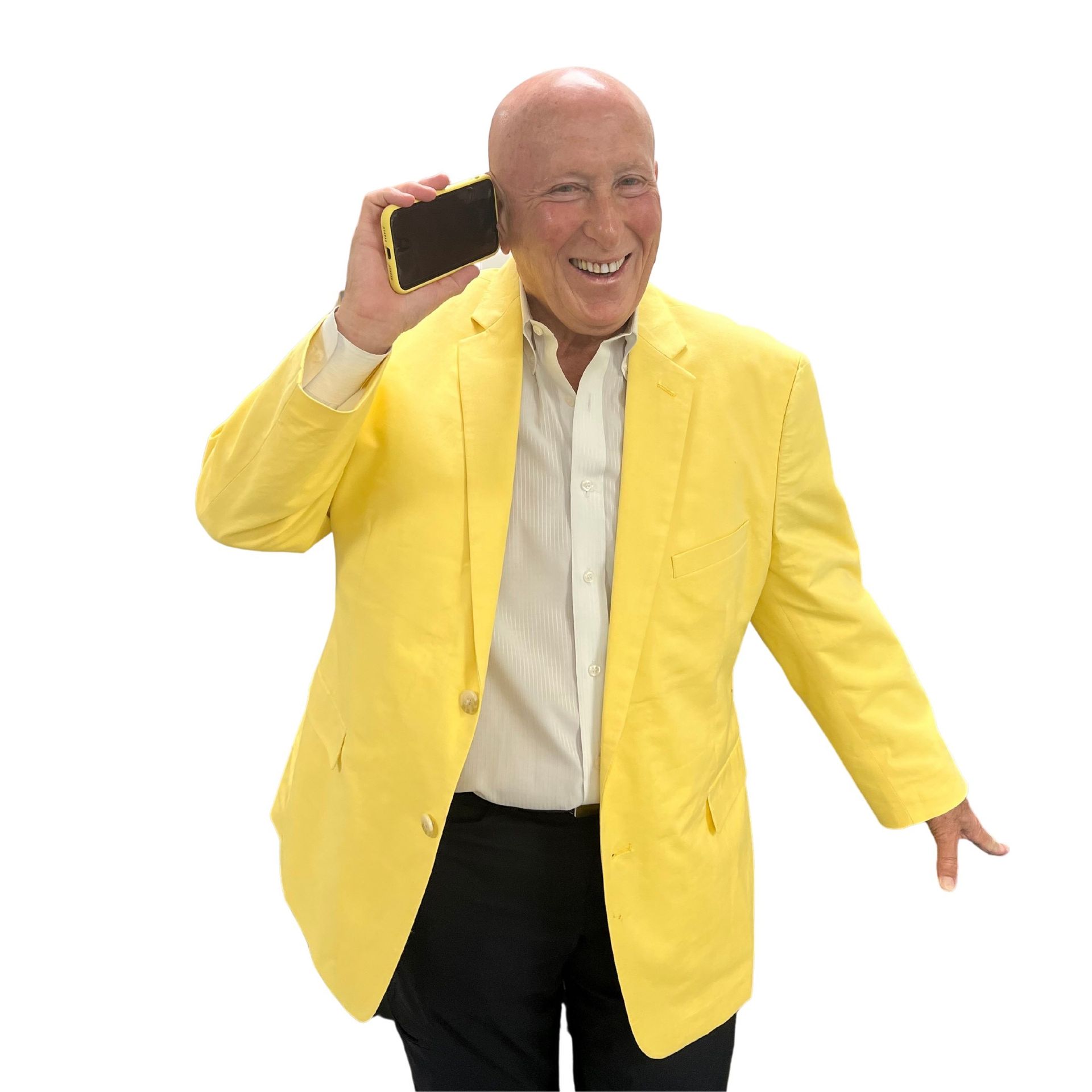 Man in yellow blazer holding phone to ear, smiling.