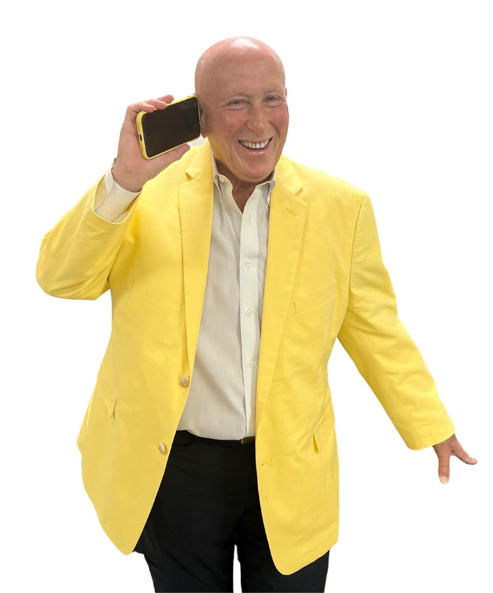 Bald man in yellow blazer holding phone, smiling.
