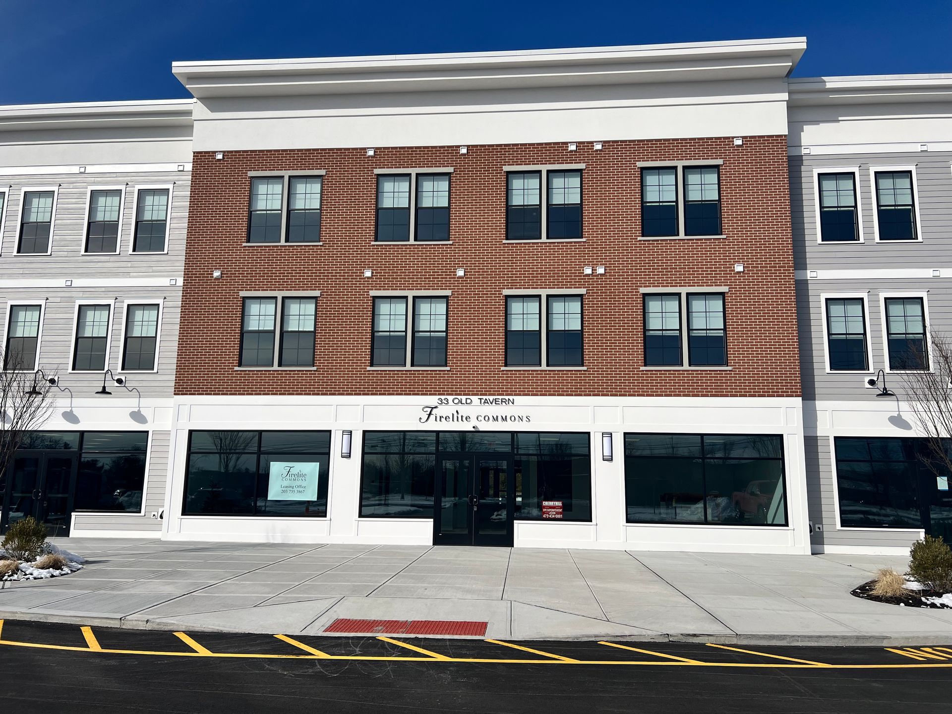 Commercial building with brick facade and large windows.  