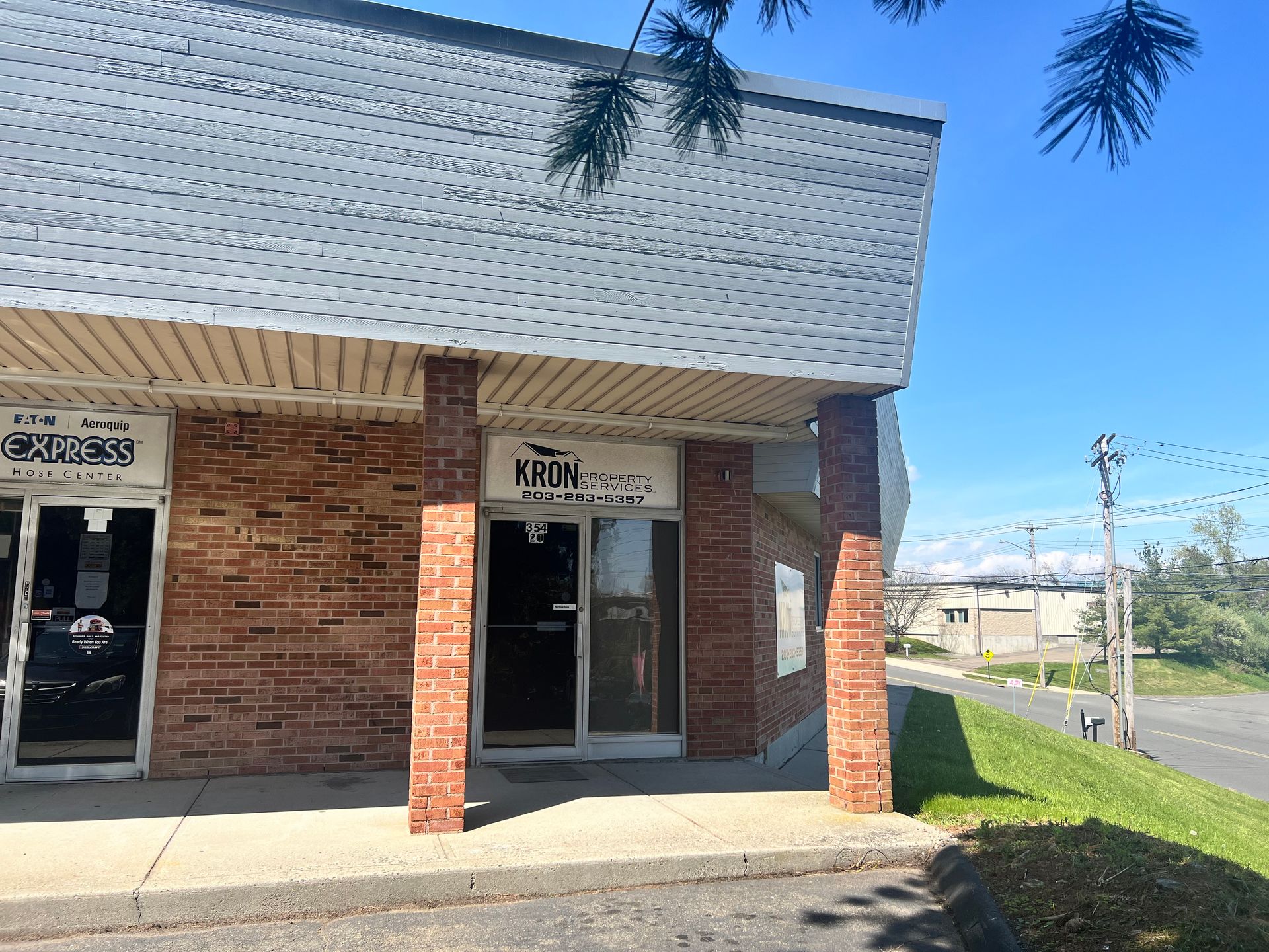Brick building with glass doors, a sign that says