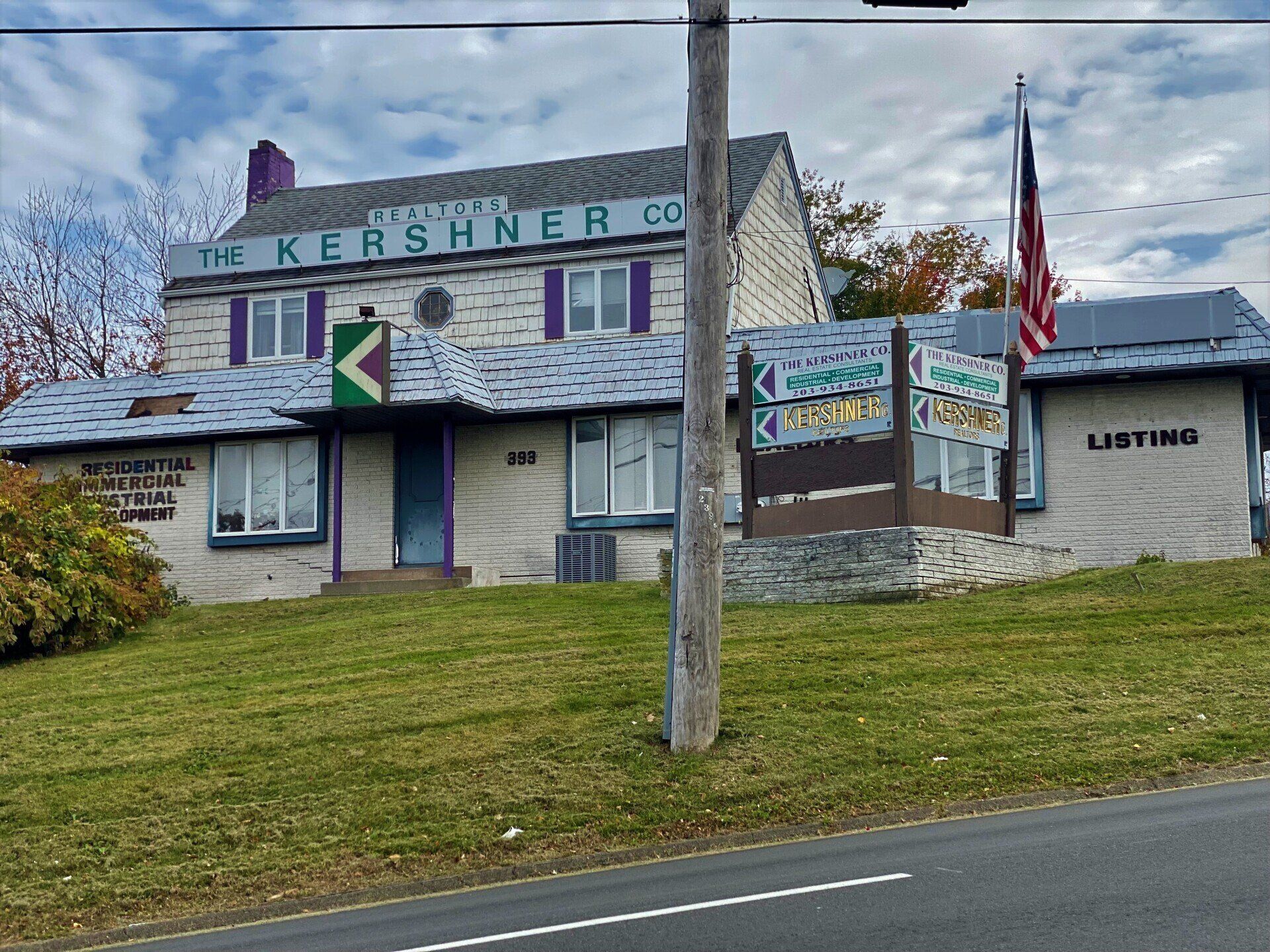 The Kershner Co. real estate office with flag, sign, and purple accents.