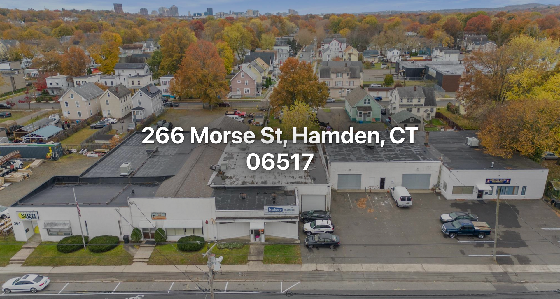 Aerial view of commercial buildings at 266 Morse St, Hamden, CT 06517, with fall foliage and parked vehicles.