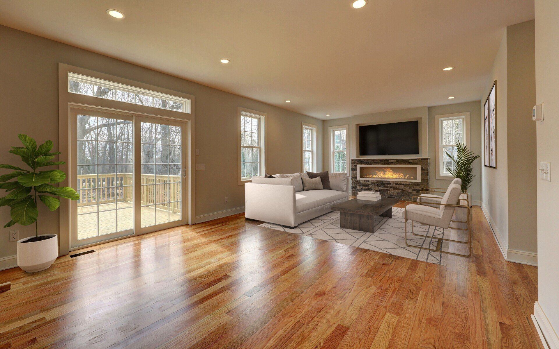 Spacious living room with hardwood floors, a sliding glass door, fireplace, and modern furniture.