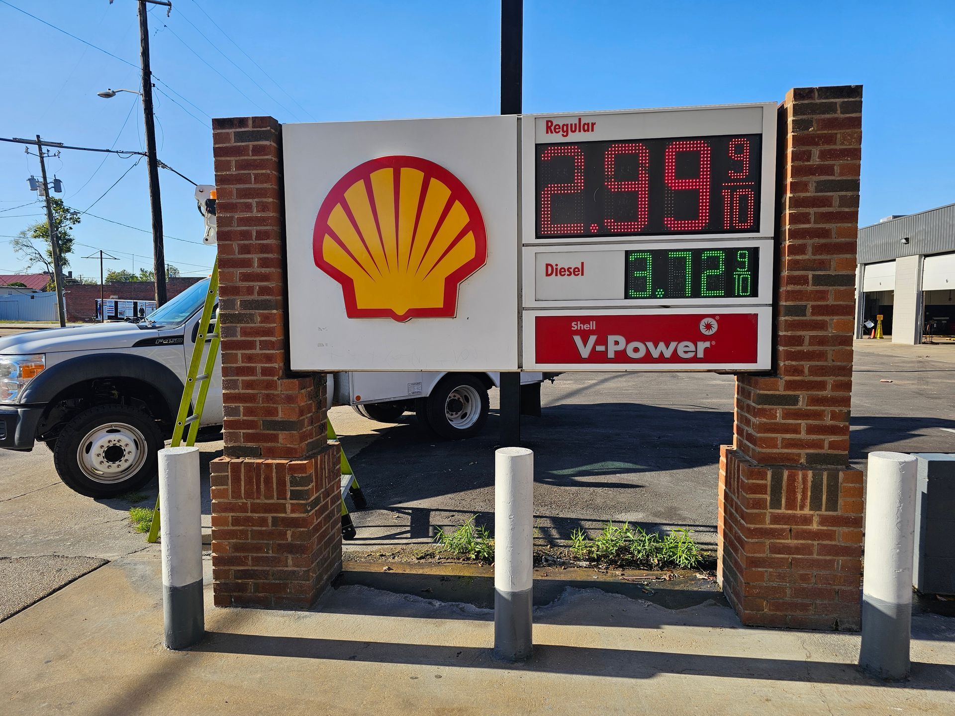 A shell gas station has a sign that says v-power