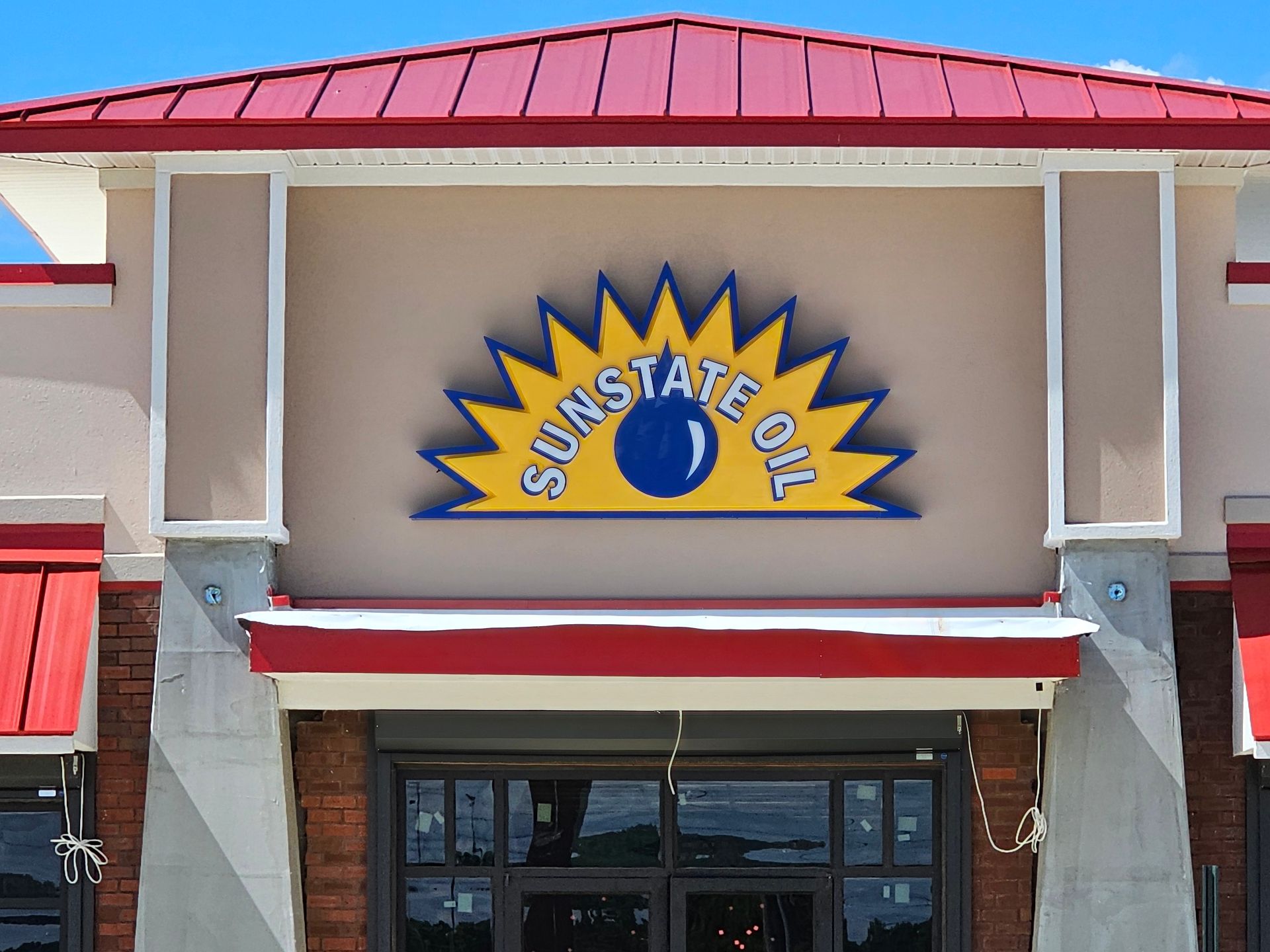 A sunstate oklahoma building with a red roof