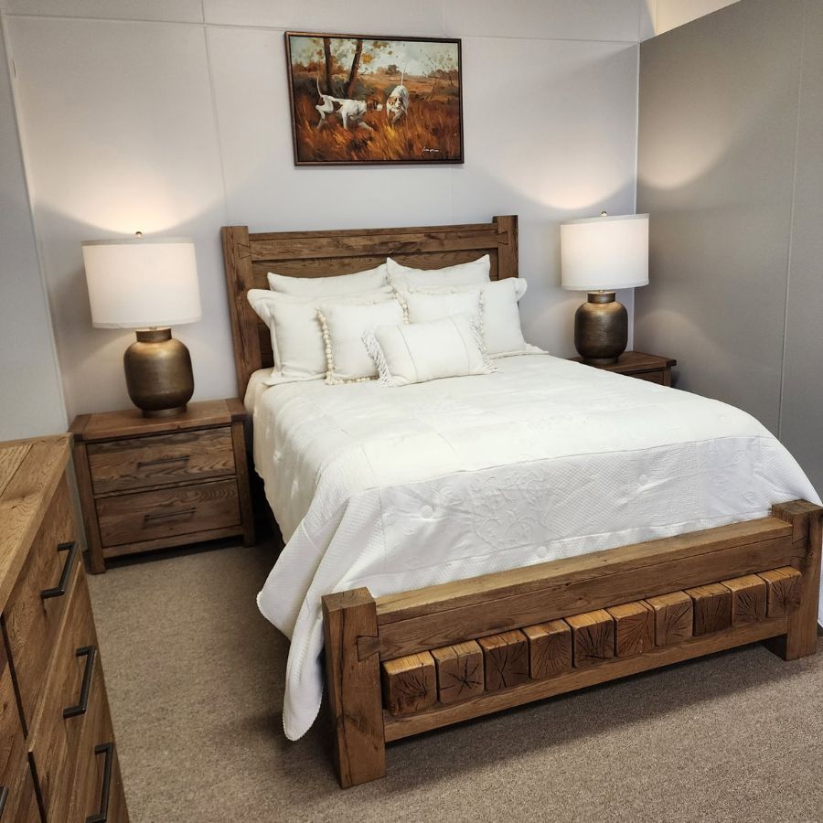 Cozy bedroom with wooden bed, white bedding, and matching bedside lamps.