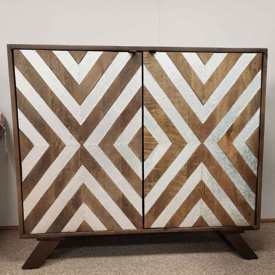 Wood cabinet with brown, white, and tan chevron geometric doors on a wooden base.