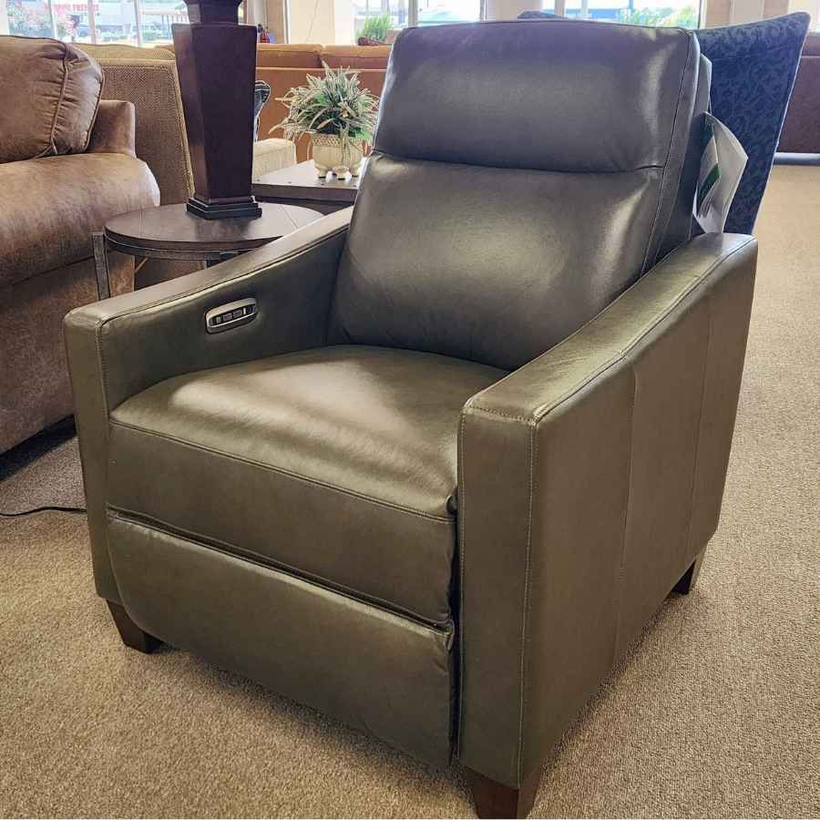 Brown leather recliner chair in a living room furniture showroom