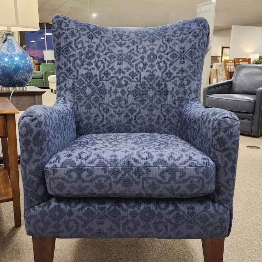 Blue patterned upholstered armchair in a furniture showroom
