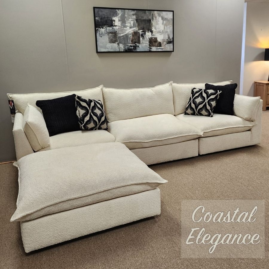 Cream sectional sofa with black-and-white pillows in a neutral living room