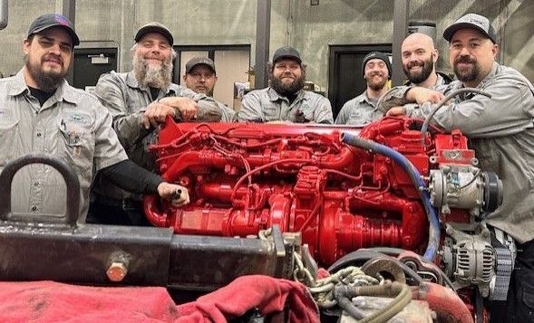 People Gathered Around An Engine