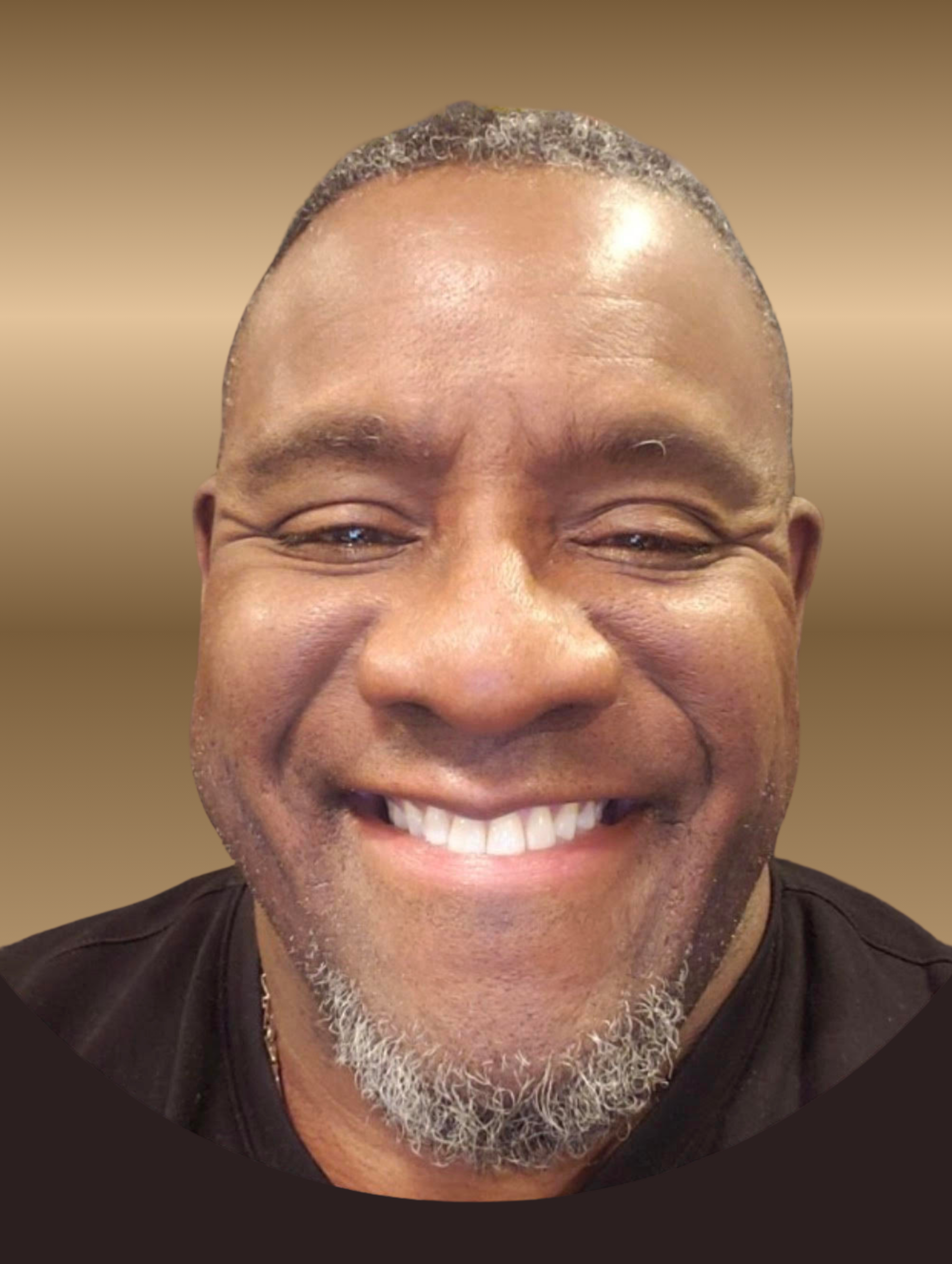 Smiling person with a shaved head and gray goatee, wearing a black shirt, against a gradient background.