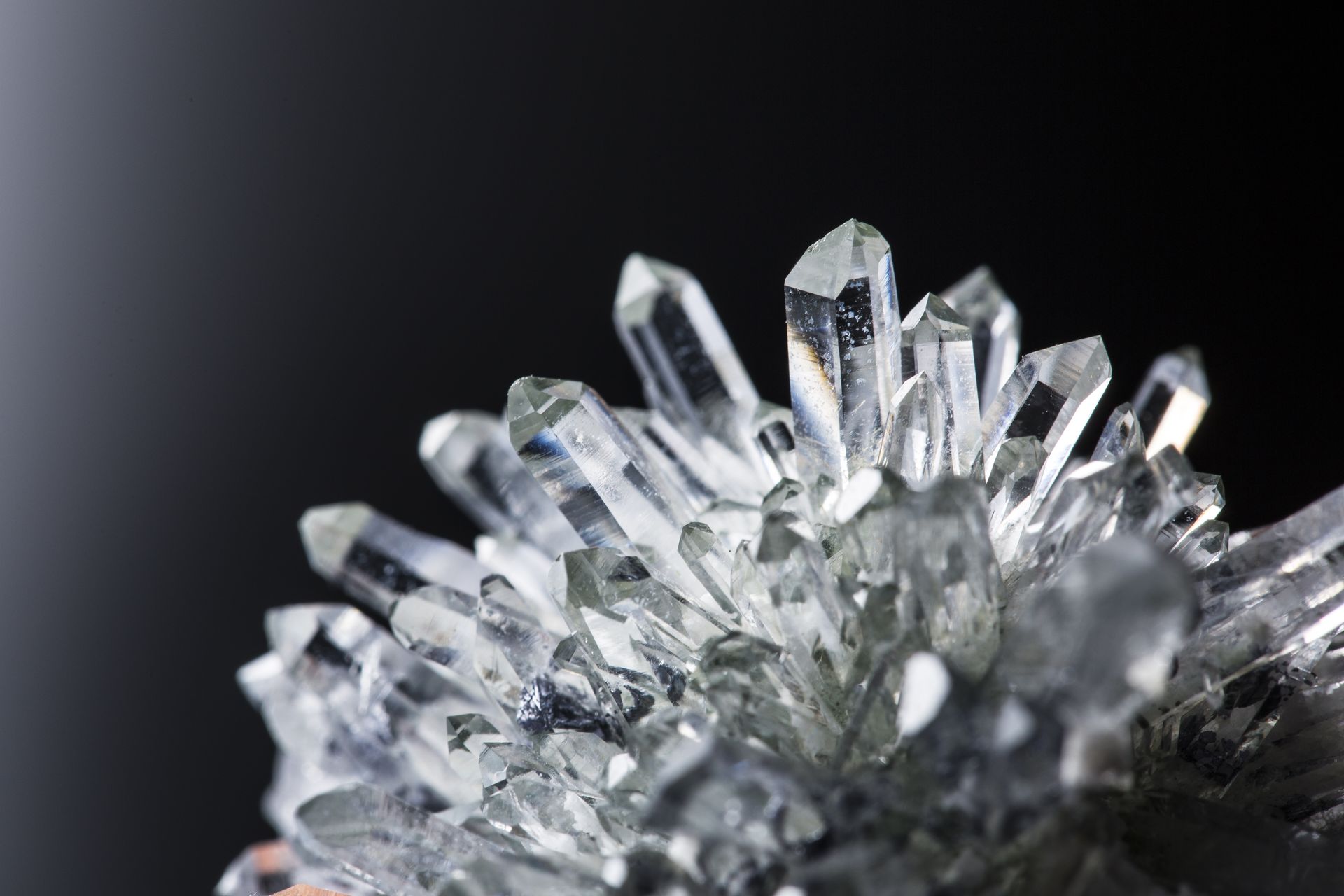 Close-up of clear quartz crystals against a dark background