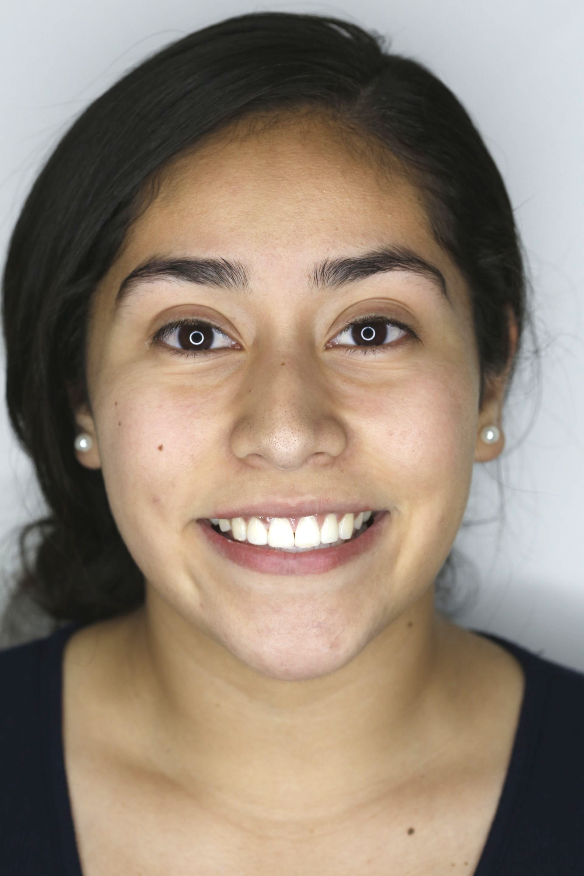 A close up of a woman 's face with a smile on her face.