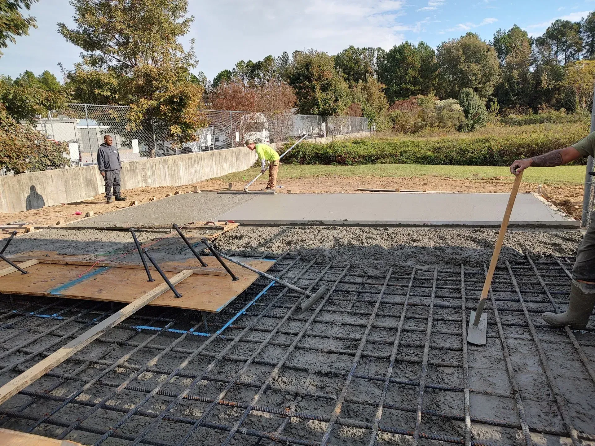 Construction site with workers preparing a rebar foundation for concrete pouring