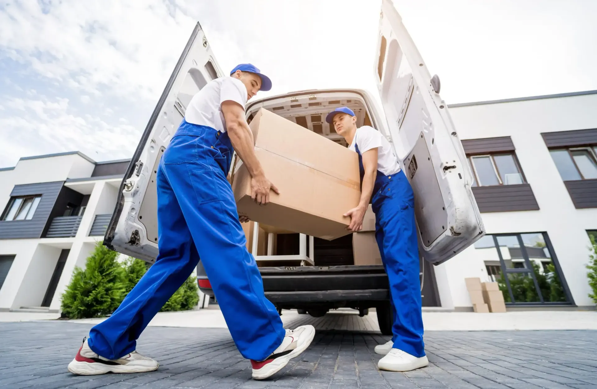 2 guys loading furniture in a truck