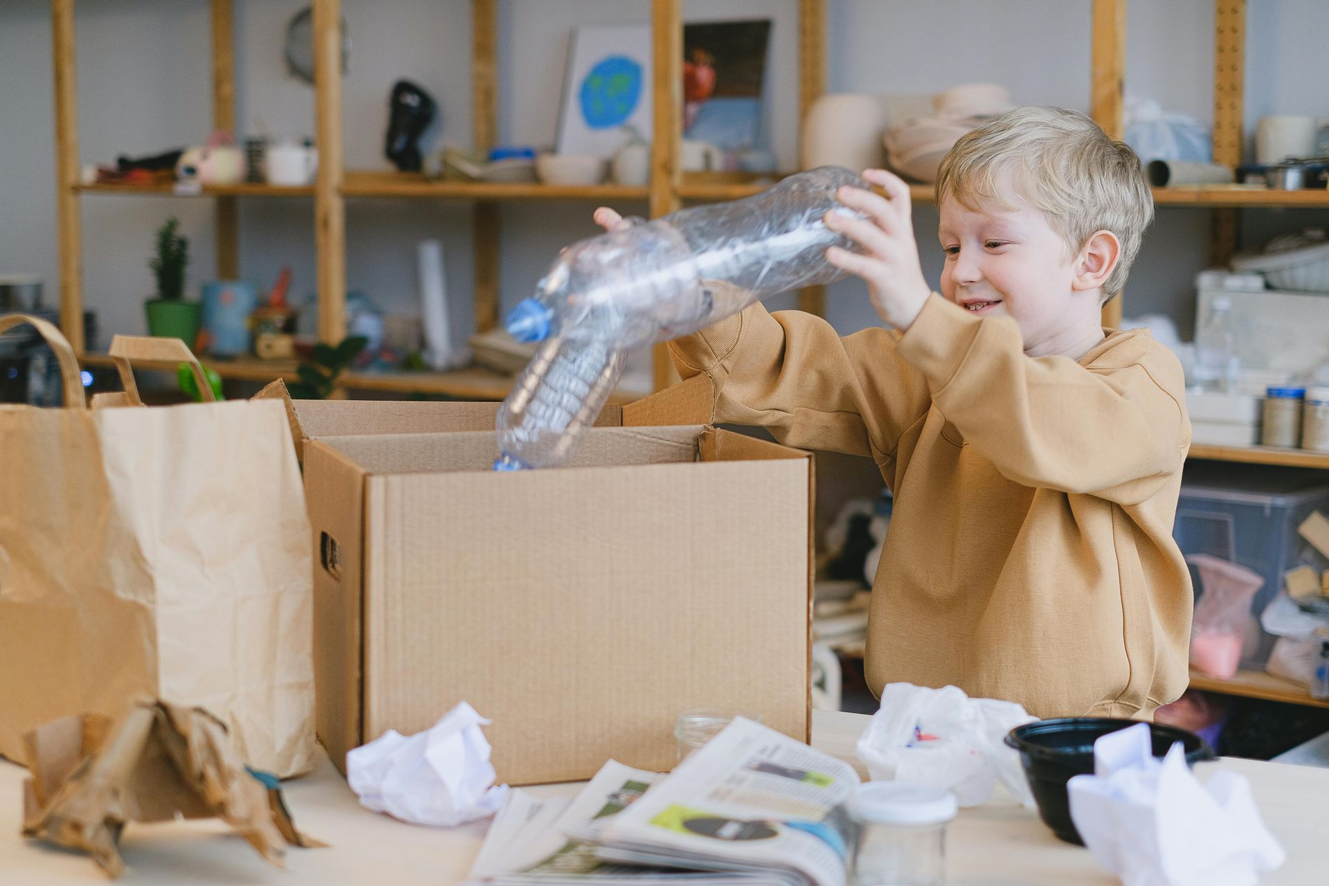 After moving, child recycles in box