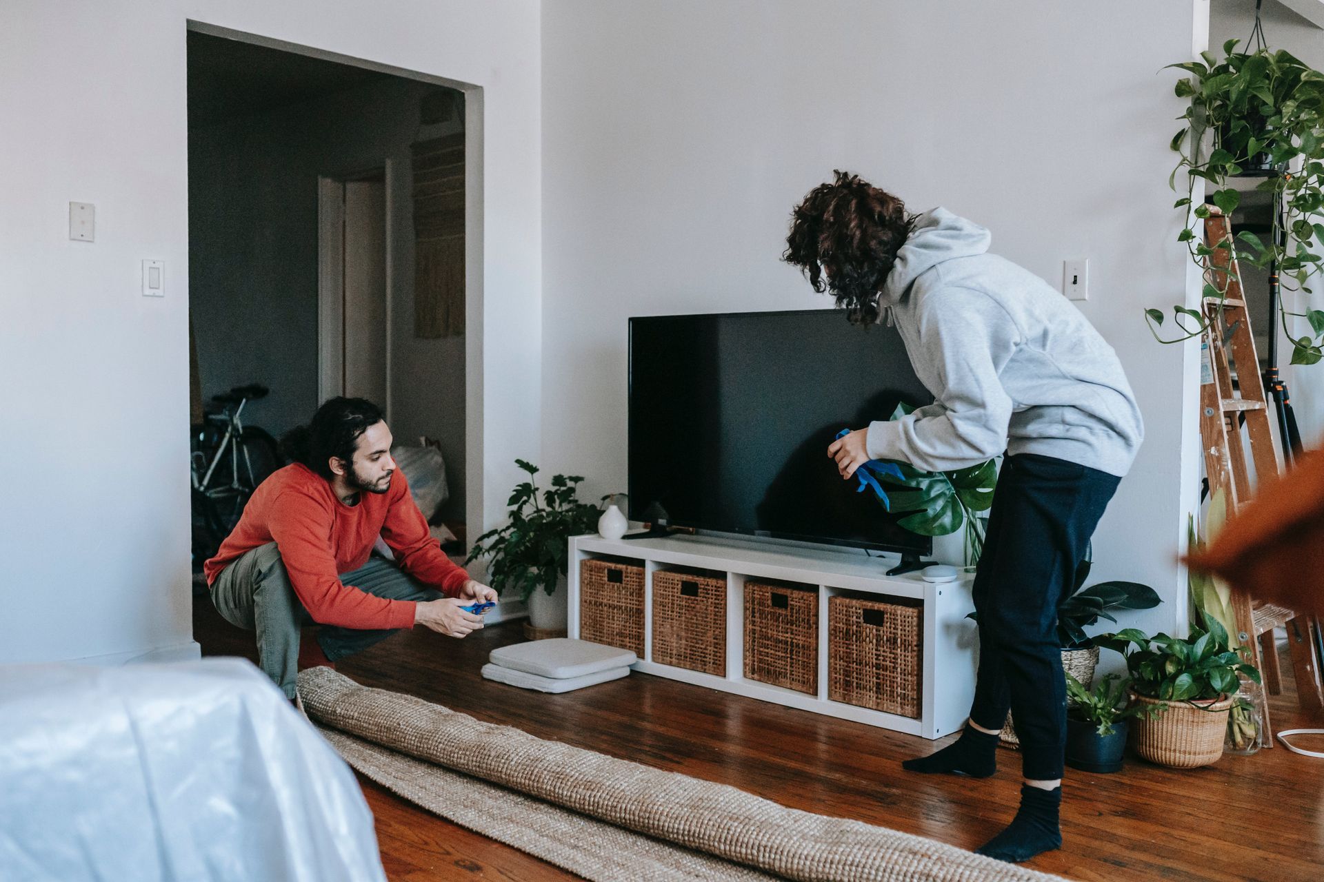 The movers are bending the carpet for moving