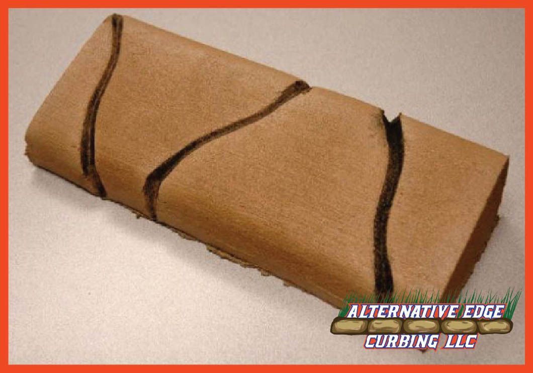 Brown leather-like material with angled cuts, folded into a tube, possibly for building material.