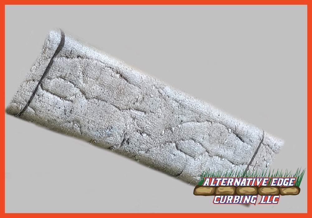 Textured stone-look edging, gray tones, angled, with 