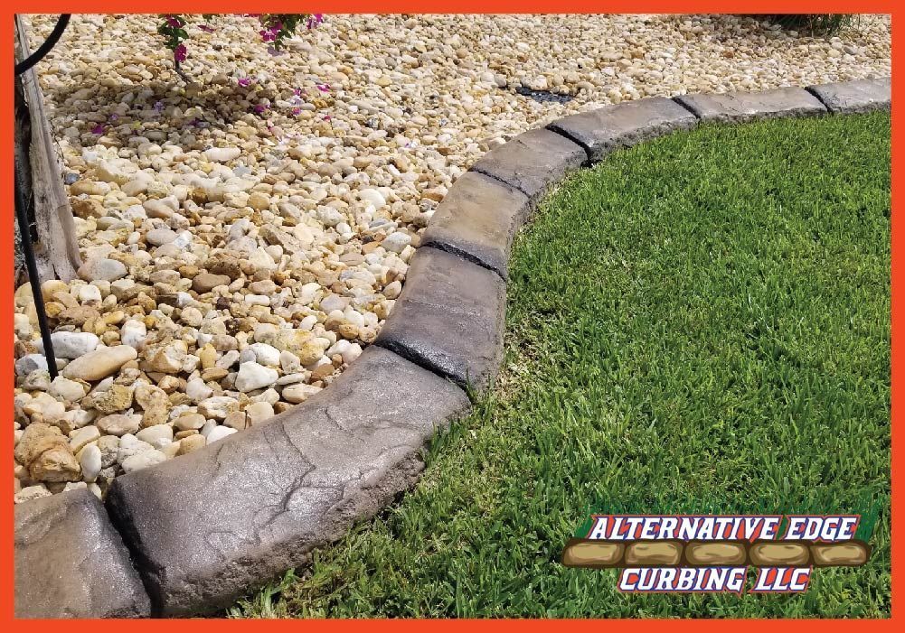 Curved concrete curbing separates gravel and grass lawn. Brown and green with logo.
