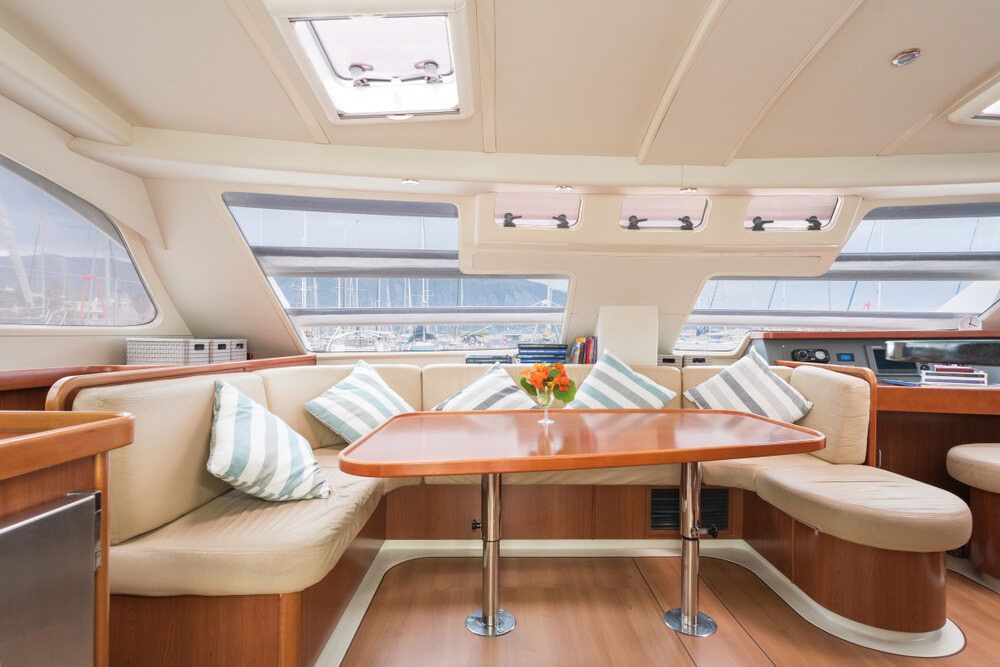A Living Room On A Boat With A Table And Couch — Coastal Upholstery In Berkeley Vale, NSW